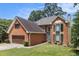 Charming brick home with an attached garage and well-manicured front yard at 1452 Crooked Tree Cir, Stone Mountain, GA 30088
