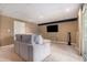 Cozy living room with a comfortable couch, large TV, and a neutral color scheme at 1452 Crooked Tree Cir, Stone Mountain, GA 30088