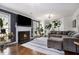 Cozy living room featuring a fireplace, hardwood floors, and lots of natural light at 1452 Crooked Tree Cir, Stone Mountain, GA 30088