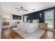 Main bedroom featuring hardwood floors, a ceiling fan, and lots of natural light at 1452 Crooked Tree Cir, Stone Mountain, GA 30088