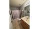 Bathroom with shower and tub, and vanity with neutral countertops at 443 Marsh Lake Rd, Lawrenceville, GA 30045