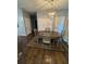 Bright dining area with hardwood floors, an elegant chandelier, and a table with seating for four at 443 Marsh Lake Rd, Lawrenceville, GA 30045