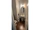 Half bathroom with a pedestal sink, a toilet, and decorative accents at 443 Marsh Lake Rd, Lawrenceville, GA 30045