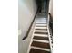 Carpeted staircase with a wooden handrail and metal spindles, leading to the upper level at 443 Marsh Lake Rd, Lawrenceville, GA 30045