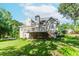 Green lawn and house with a backyard deck at 1100 Midland Way, Lawrenceville, GA 30043
