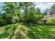 Spacious backyard with mature trees and a stone picnic table, creating a serene outdoor space at 1100 Midland Way, Lawrenceville, GA 30043