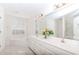 Bright bathroom featuring double vanity, tub under window, and expansive mirror at 1100 Midland Way, Lawrenceville, GA 30043