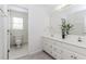 Bathroom with double vanity, toilet, and window for natural light at 1100 Midland Way, Lawrenceville, GA 30043