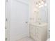 Bathroom featuring white cabinet, sink, and neutral colors at 1100 Midland Way, Lawrenceville, GA 30043