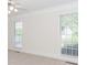 Bright bedroom featuring neutral decor and two windows with natural light at 1100 Midland Way, Lawrenceville, GA 30043