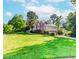 Expansive two-story brick home with a lush lawn, mature trees and attached two-car garage at 1100 Midland Way, Lawrenceville, GA 30043