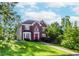 Charming brick two-story home with a red front door, lush lawn, and mature trees at 1100 Midland Way, Lawrenceville, GA 30043