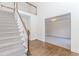 Bright foyer features hardwood flooring, staircase and chandelier visible in adjacent room at 1100 Midland Way, Lawrenceville, GA 30043