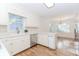Bright, white kitchen with stainless steel appliances, hardwood floors, and an adjacent eating area at 1100 Midland Way, Lawrenceville, GA 30043