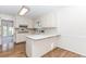 Well-lit kitchen with white cabinetry, light countertops, and hardwood flooring at 1100 Midland Way, Lawrenceville, GA 30043