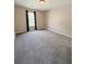 Bedroom with plush carpeting, neutral walls and a window dressed with dark-colored curtains at 1581 Shetland Pony Ct, Suwanee, GA 30024