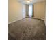 Bedroom with plush carpeting and neutral walls with light pouring in through the curtains at 1581 Shetland Pony Ct, Suwanee, GA 30024