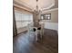 Elegant dining room with hardwood floors, stylish lighting, and a four-person table at 1581 Shetland Pony Ct, Suwanee, GA 30024