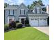 Charming two-story home featuring a well-manicured lawn and a convenient two-car garage at 1581 Shetland Pony Ct, Suwanee, GA 30024