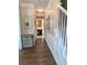 Hallway featuring attractive wood-look flooring and access to the staircase and the kitchen at 1581 Shetland Pony Ct, Suwanee, GA 30024