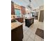 Spacious kitchen with island, granite counters, stainless appliances, and an open view of the living room at 1581 Shetland Pony Ct, Suwanee, GA 30024