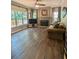 Inviting living room featuring hardwood floors, a fireplace, and large windows with scenic views at 1581 Shetland Pony Ct, Suwanee, GA 30024