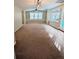 Bright living room featuring neutral carpet, a ceiling fan, and windows for ample natural light at 1581 Shetland Pony Ct, Suwanee, GA 30024