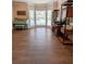 Bright living room features hardwood floors, large windows, and a decorative blue piano at 1581 Shetland Pony Ct, Suwanee, GA 30024