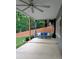 Covered patio area featuring comfortable seating and a view of the green backyard at 1581 Shetland Pony Ct, Suwanee, GA 30024