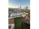 Rooftop balcony featuring artificial turf and a hanging chair with skyline views at 285 Centennial Olympic Park Nw Dr # 1905, Atlanta, GA 30339