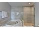 Elegant bathroom featuring a soaking tub and a separate glass-enclosed shower, perfect for relaxation at 285 Centennial Olympic Park Nw Dr # 1905, Atlanta, GA 30339