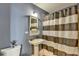 Traditional bathroom with a pedestal sink and shower-tub combination with striped curtain for privacy and style at 285 Centennial Olympic Park Nw Dr # 1905, Atlanta, GA 30339