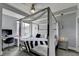 Modern bedroom with canopy bed, desk, and large window offering natural light and city views at 285 Centennial Olympic Park Nw Dr # 1905, Atlanta, GA 30339