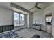Bright bedroom featuring a large window with city views, carpeted floor, and a modern ceiling fan at 285 Centennial Olympic Park Nw Dr # 1905, Atlanta, GA 30339
