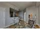 Open dining area with a modern table setting and seating next to an adjacent kitchen and hallway at 285 Centennial Olympic Park Nw Dr # 1905, Atlanta, GA 30339
