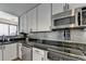 Kitchen featuring stainless appliances, granite counters, and views of the living area at 285 Centennial Olympic Park Nw Dr # 1905, Atlanta, GA 30339