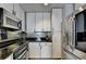 Modern kitchen with sleek stainless steel appliances, granite countertops, and stylish white cabinetry at 285 Centennial Olympic Park Nw Dr # 1905, Atlanta, GA 30339