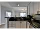 Modern kitchen with stainless steel appliances and granite countertops open to living area at 285 Centennial Olympic Park Nw Dr # 1905, Atlanta, GA 30339