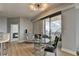 Open-concept living space featuring a dining area, balcony access, and wood flooring throughout at 285 Centennial Olympic Park Nw Dr # 1905, Atlanta, GA 30339