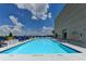 Outdoor swimming pool with clear blue water, surrounded by lounge chairs and potted plants at 285 Centennial Olympic Park Nw Dr # 1905, Atlanta, GA 30339