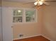 Bedroom featuring hardwood floors, neutral paint, and natural light from windows at 3293 Oakcliff Rd, Doraville, GA 30340