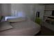 Cozy bedroom featuring simple furniture and a light pink bedspread at 3293 Oakcliff Rd, Doraville, GA 30340