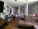 Spacious living room features hardwood floors, a comfortable brown sectional, and a staircase leading upstairs at 3293 Oakcliff Rd, Doraville, GA 30340