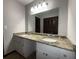 Bathroom featuring double sinks with granite countertops and large mirror at 420 Creekview Ct, Marietta, GA 30064