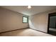 Neutral bedroom with carpet, window offering natural light, and adjacent doorway at 420 Creekview Ct, Marietta, GA 30064