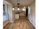 Open dining area with modern lighting fixtures and hardwood floors overlooking the kitchen at 420 Creekview Ct, Marietta, GA 30064