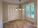 Dining area with modern lighting fixtures, hardwood floors, a window and closet space at 420 Creekview Ct, Marietta, GA 30064