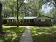 Charming single-story brick home with mature trees and a stone walkway at 420 Creekview Ct, Marietta, GA 30064