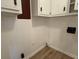 Laundry room with white paneled walls and hardwood floors at 420 Creekview Ct, Marietta, GA 30064