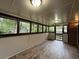 Enclosed sunroom with many windows and wood flooring at 420 Creekview Ct, Marietta, GA 30064